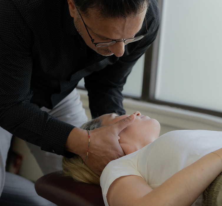 Chiropractic Dr giving neck treatment to woman